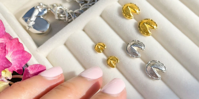 Fortune cookie stud earrings in gold and silver.